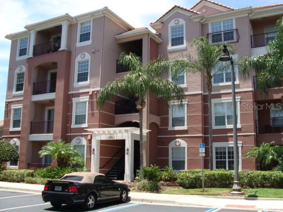 Front view of a multi-story residential building with balconies.