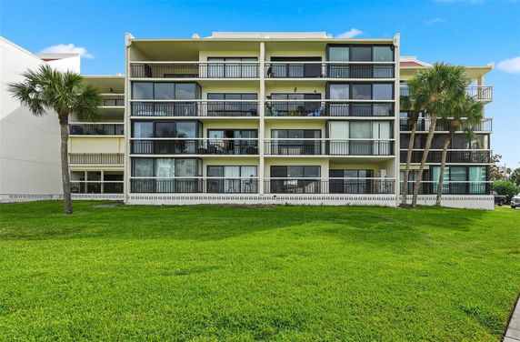 Front view of a multi-story apartment building with balconies.