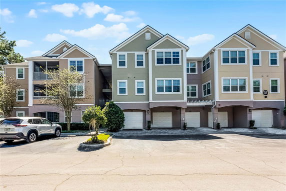 Front view of a multi-story residential building with garages.