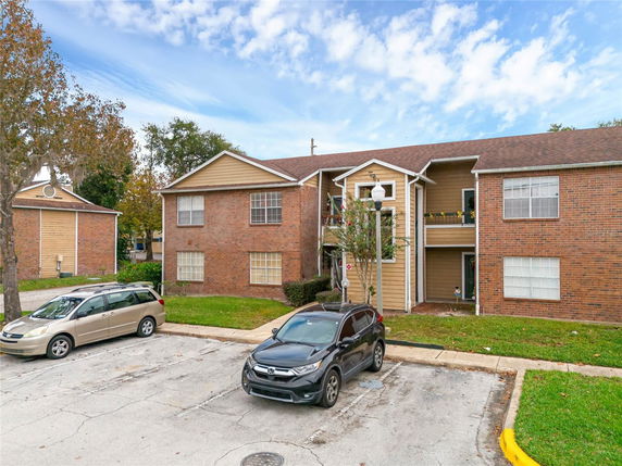 Front view of a two-story apartment building with brick and siding exterior.