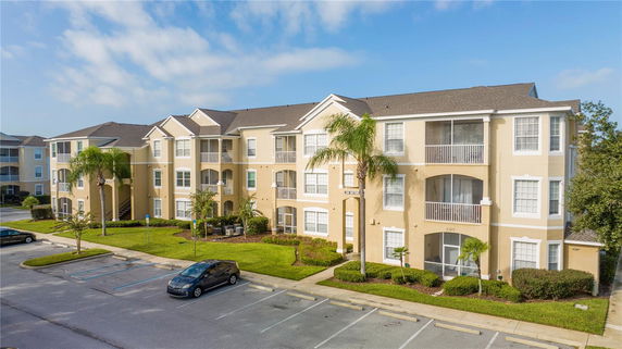 Front view of a multi-story apartment building with balconies.