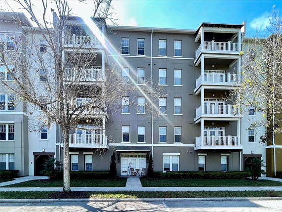 Front view of a multi-story residential building with balconies.