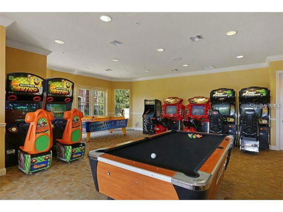 Indoor recreational area with arcade games and a pool table.