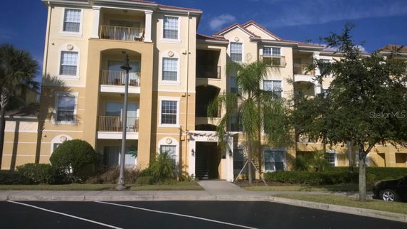 Front view of a multi-story apartment building with balconies.