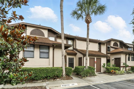 Front view of a two-story residential building with brown accents.