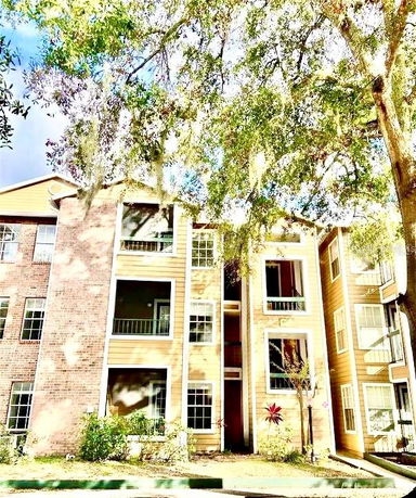 Front view of a multi-story apartment building with balconies and windows.