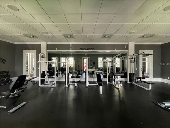 Interior view of a gym room with exercise equipment.