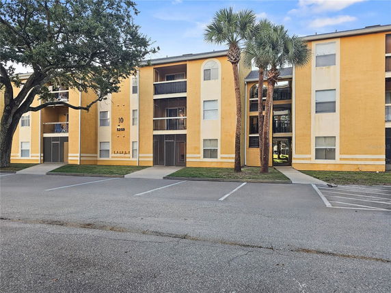 Front view of a multi-story apartment building with balconies.