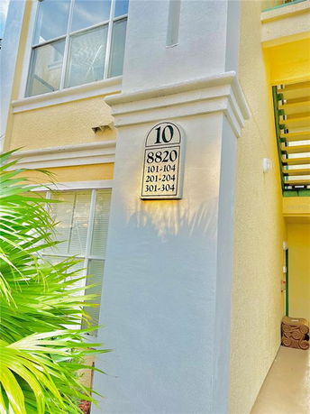 Exterior section of a building showing the entrance and apartment numbers.