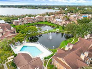 Aerial view of a residential complex with a central fountain pond and surrounding buildings.