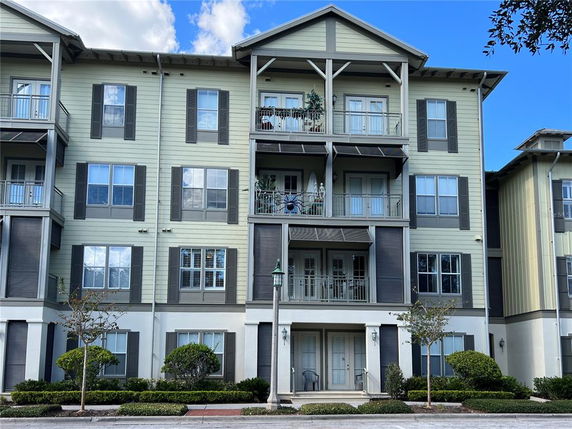 Front view of a multi-story residential building with balconies.