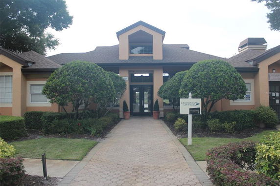 Front view of a single-story building with a pathway leading to the entrance.