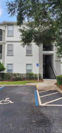 Front view of a three-story apartment building with external staircases.