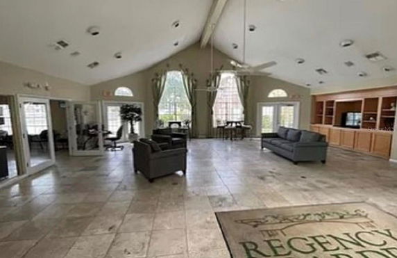 Interior view of a room with seating arrangements and large windows.
