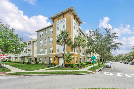 Front view of a multi-story apartment building with a corner design.