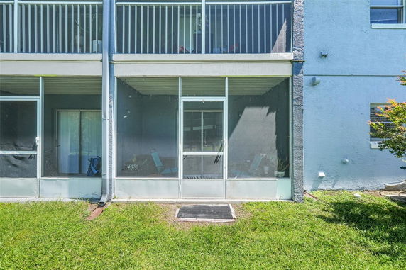 Front view of a house with screened porch.