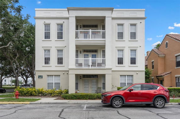 Front view of a multi-story residential building with balconies.