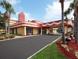 Front view of a building with a distinct red roof and entrance area.