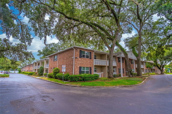 Front view of a two-story brick apartment building with balconies.