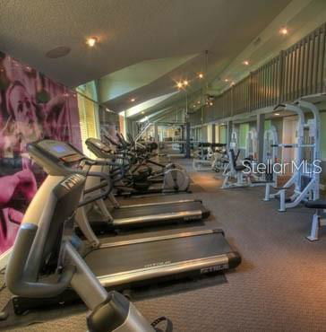 Interior view of a gym with treadmills and exercise equipment.