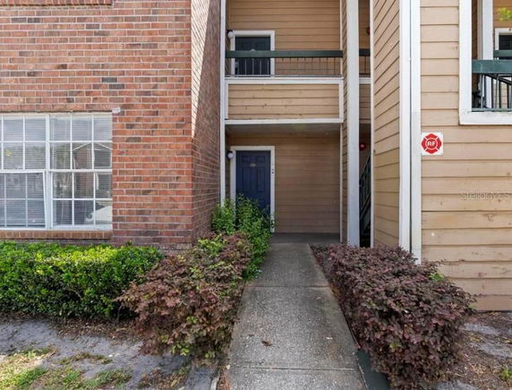 Entrance view of a residential building with brick and siding exterior.