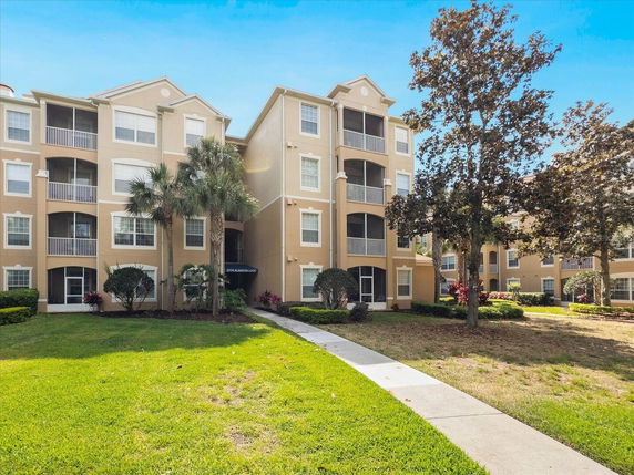 Front view of a multi-story apartment building with balconies.