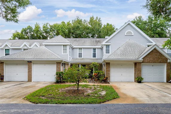 Front view of a multi-unit townhouse with attached garages.