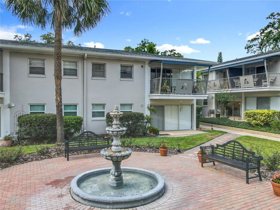 Front view of a residential building with two stories and balconies.