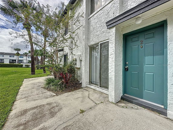 Front view of a house with a green door and white exterior walls.