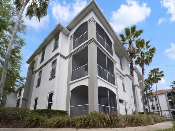 Front view of a three-story residential building with balconies.