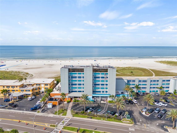 Front view of a hotel building with multiple stories located near the beach.