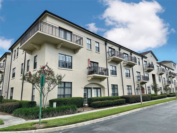 Front view of a multi-story apartment building with balconies.