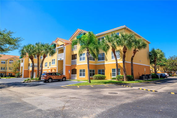 Front view of a multi-story apartment building with balconies.