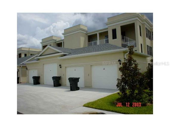 Front view of a multi-story building with multiple garage doors.