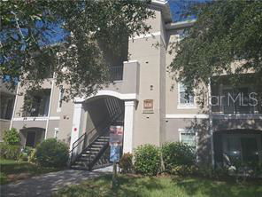 Front view of a multi-story building with an exterior staircase.