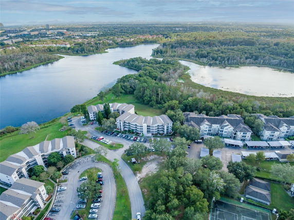 Aerial view of a residential complex surrounded by lakes and greenery.
