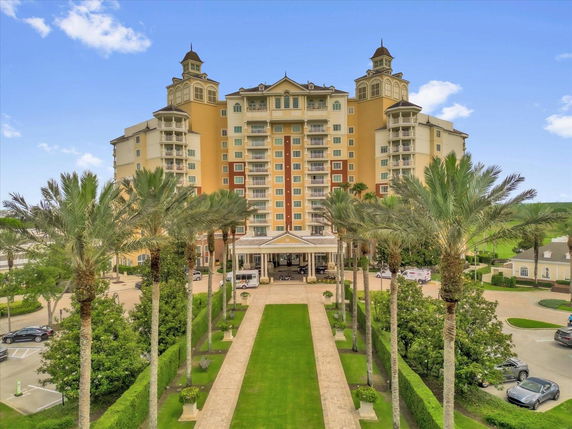 Front view of a multi-story building with ornate towers and balconies.