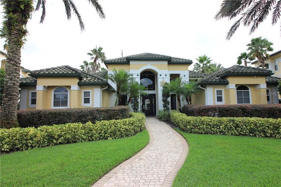 Front view of a single-story house with a tiled roof and arched entrance.