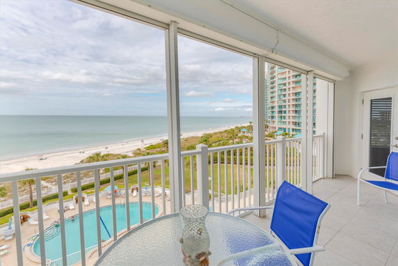 Ocean view from a balcony with a swimming pool below.