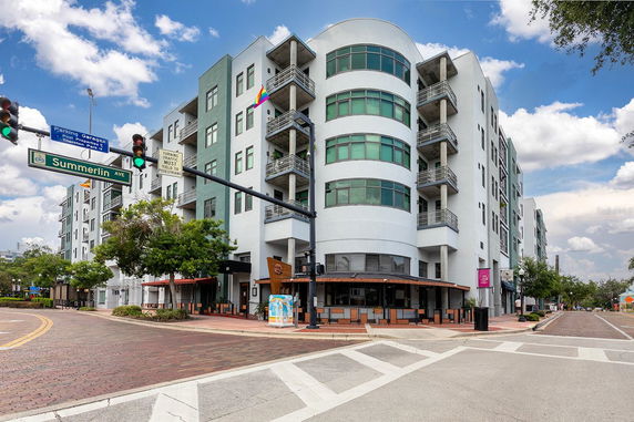 Front view of a multi-story building with balconies and curved facade.