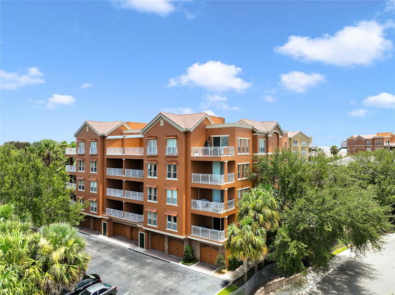 Front view of a multi-story apartment building with balconies.