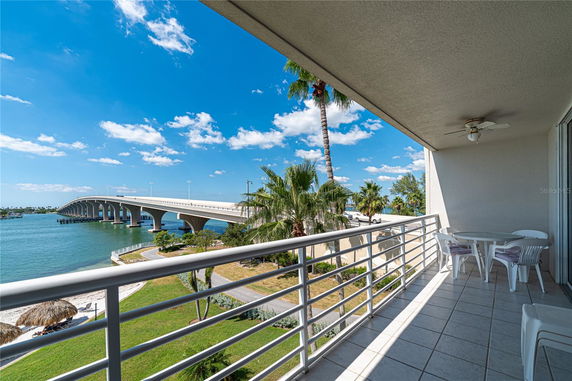 Balcony overlooking a scenic waterfront and bridge.