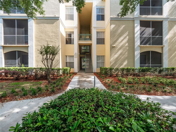 Front view of a multi-story residential building with balconies.