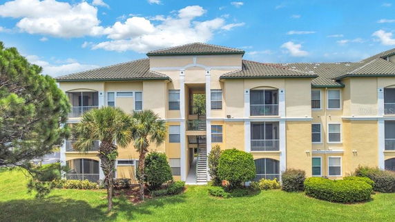 Front view of a multi-story residential building with balconies.