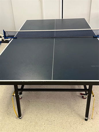 Table tennis setup inside a building.