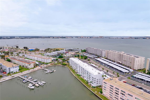 Panoramic view of waterfront buildings and a marina with boats along the shoreline.
