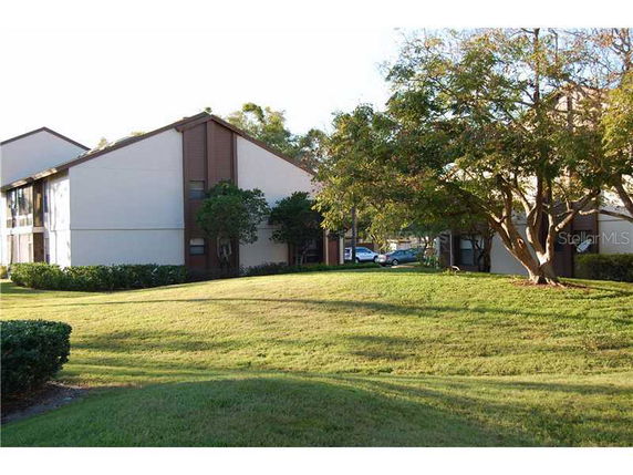 Front view of a two-story building with sloped roof and brown trim.