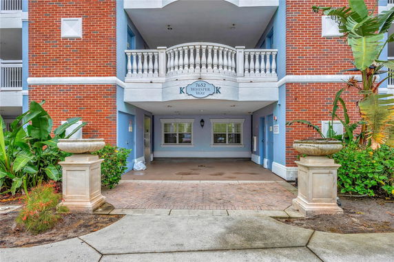 Front view of a building entrance with a brick and blue exterior.