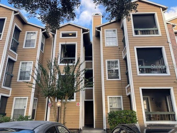 Front view of a multi-story residential building with multiple balconies.