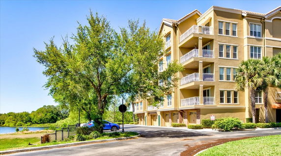 Front view of a multi-story apartment building with balconies.